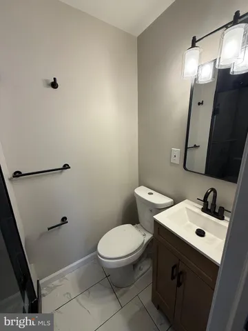 a bathroom with a sink a toilet and mirror