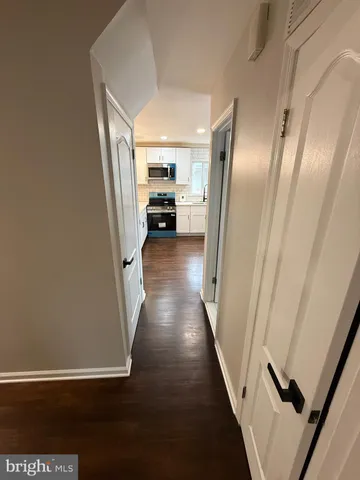 a view of a hallway with wooden floor