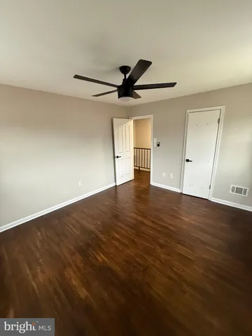 a view of an empty room and wooden floor