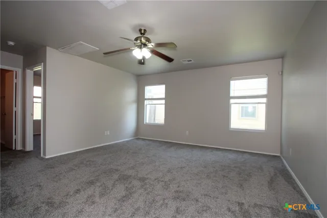 a view of an empty room with a window