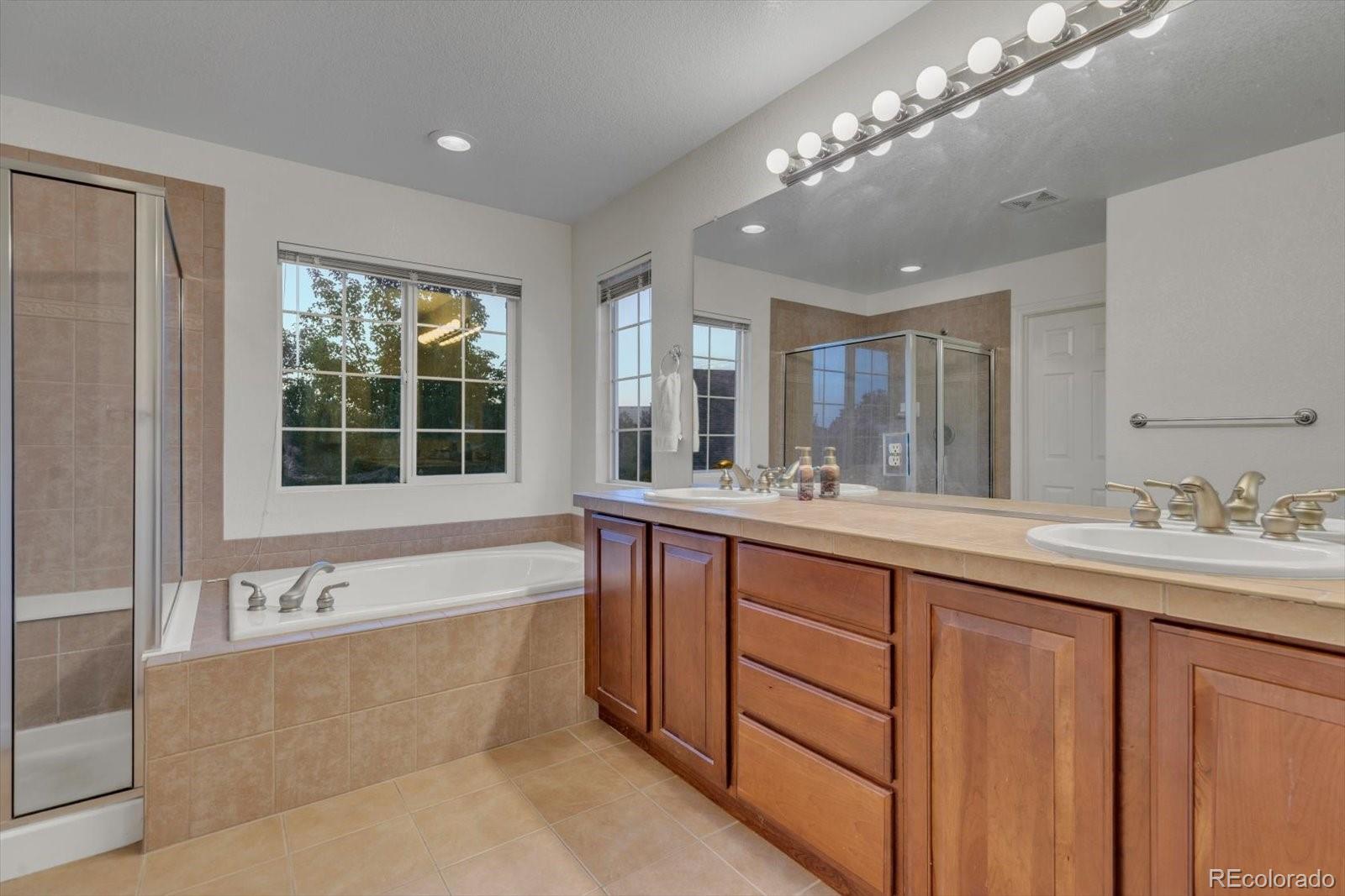 4786 Rabbit Mountain Road Broomfield, CO 80020 - Photo 19 of 41 a spacious bathroom with a large tub sink and window