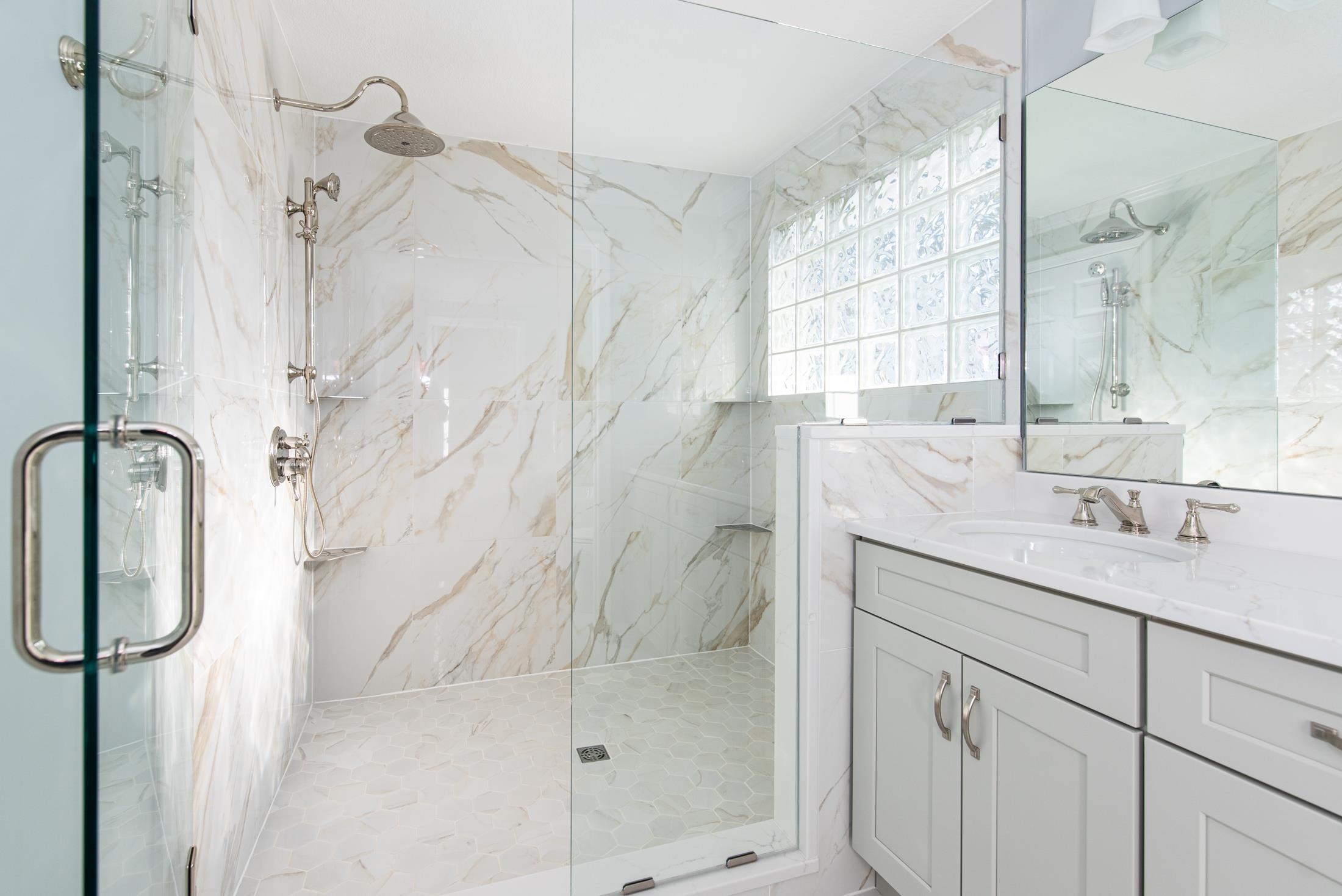141 Jupiter Road St. Augustine, FL 32086 - Photo 34 of 48 a bathroom with a granite countertop sink a shower and a mirror
