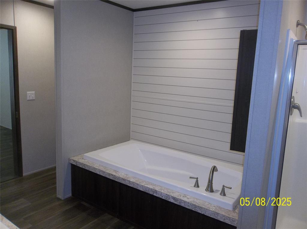 531 Blair Road Waxahachie, TX 75165 - Photo 25 of 40 Bathroom with a garden tub and dark wood finished floors