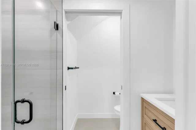 a bathroom with a granite countertop sink