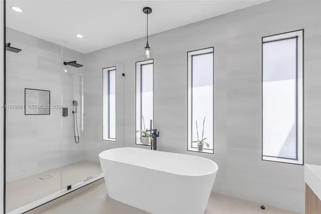 a white bath tub sitting next to a window