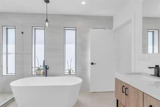 a spacious bathroom with a bathtub and sink
