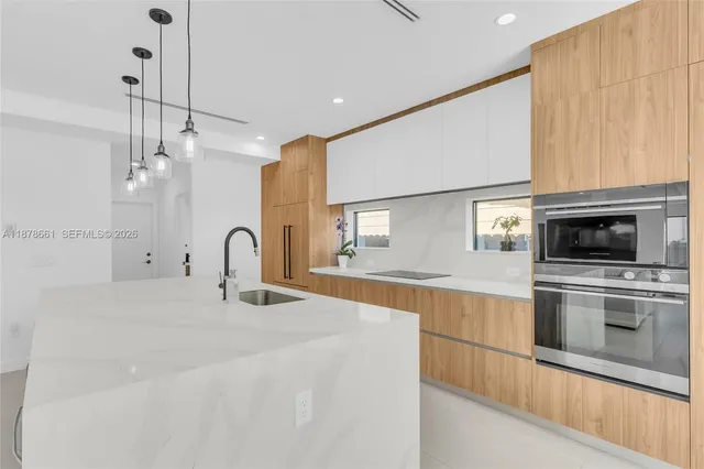 a kitchen with stainless steel appliances a stove sink and cabinets