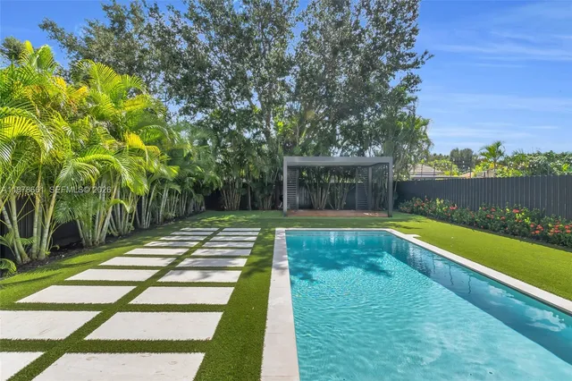 a view of swimming pool with chairs in patio