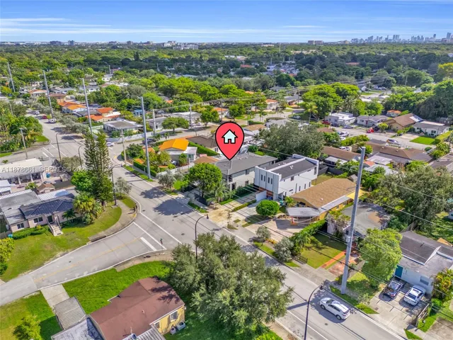 a front view of a house with a garden and tree