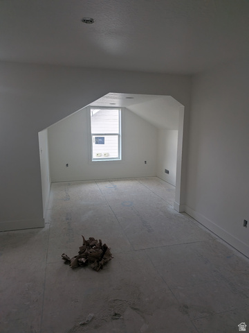 2771 West Aurora Avenue Mapleton, UT 84664 - Photo 24 of 39 Bright interior space featuring a window with white trim, angled ceilings, recessed lighting, and a neutral color palette