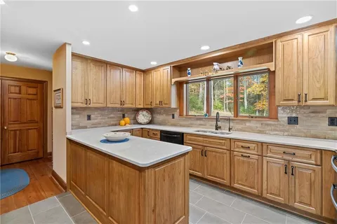 a bathroom with a granite countertop toilet sink and mirror