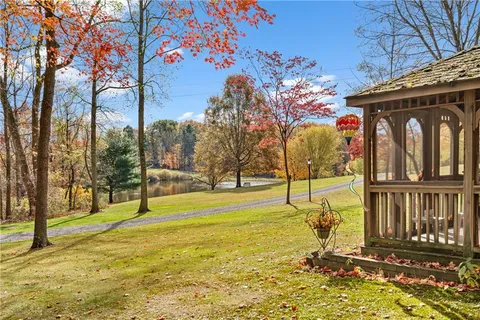 a front view of house with yard and green space