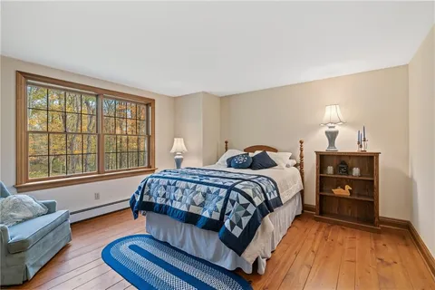 a view of a field with trees in front of main door