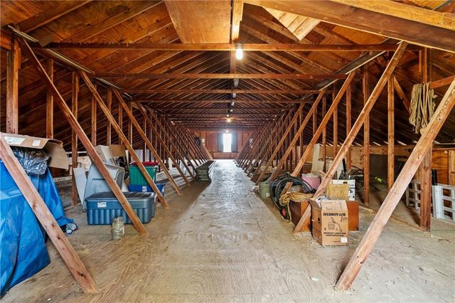 a view of a yard with plants and wooden fence