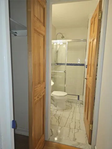 a bathroom with a glass shower door
