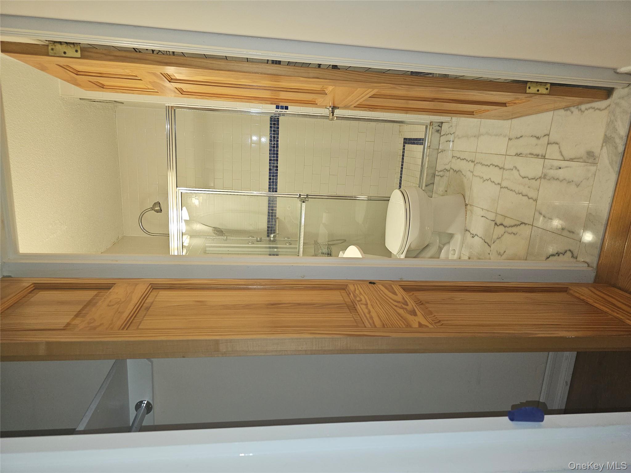 41-40 Union Street, Unit 10P Queens, NY 11355 - Photo 11 of 12 a bathroom with a glass shower door