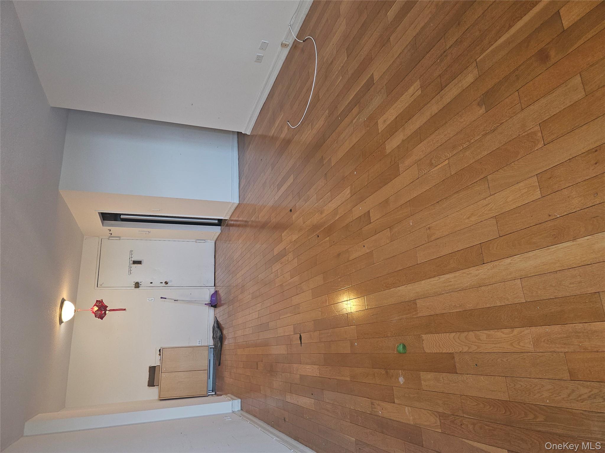 41-40 Union Street, Unit 10P Queens, NY 11355 - Photo 3 of 12 a view of empty room with wooden floor