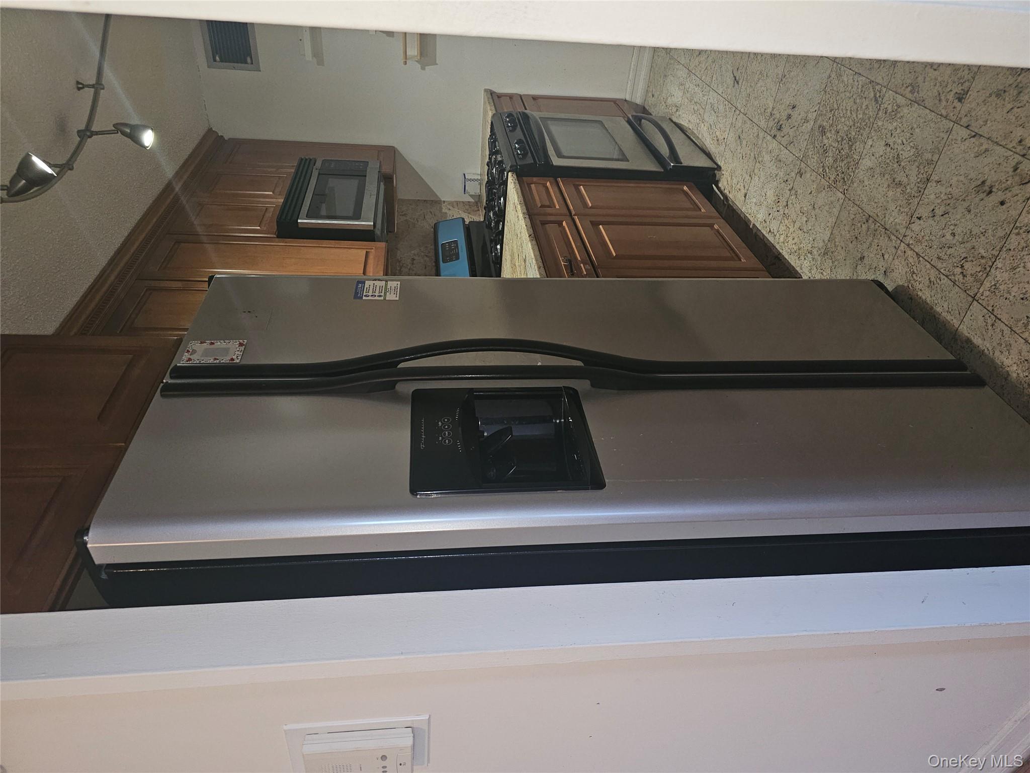 41-40 Union Street, Unit 10P Queens, NY 11355 - Photo 6 of 12 a kitchen with stainless steel appliances granite countertop a refrigerator and a sink