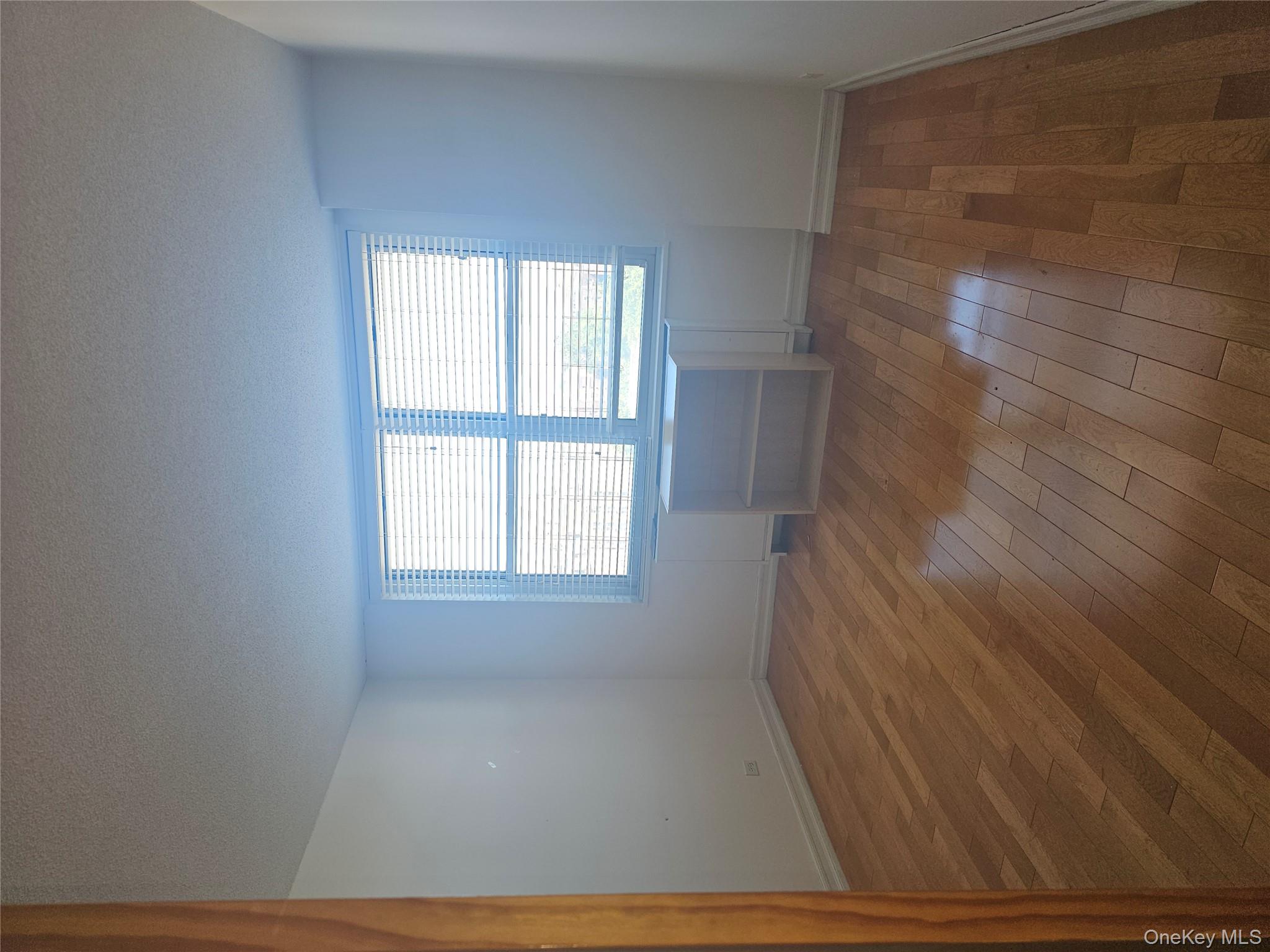 41-40 Union Street, Unit 10P Queens, NY 11355 - Photo 10 of 12 an empty room with wooden floor and windows