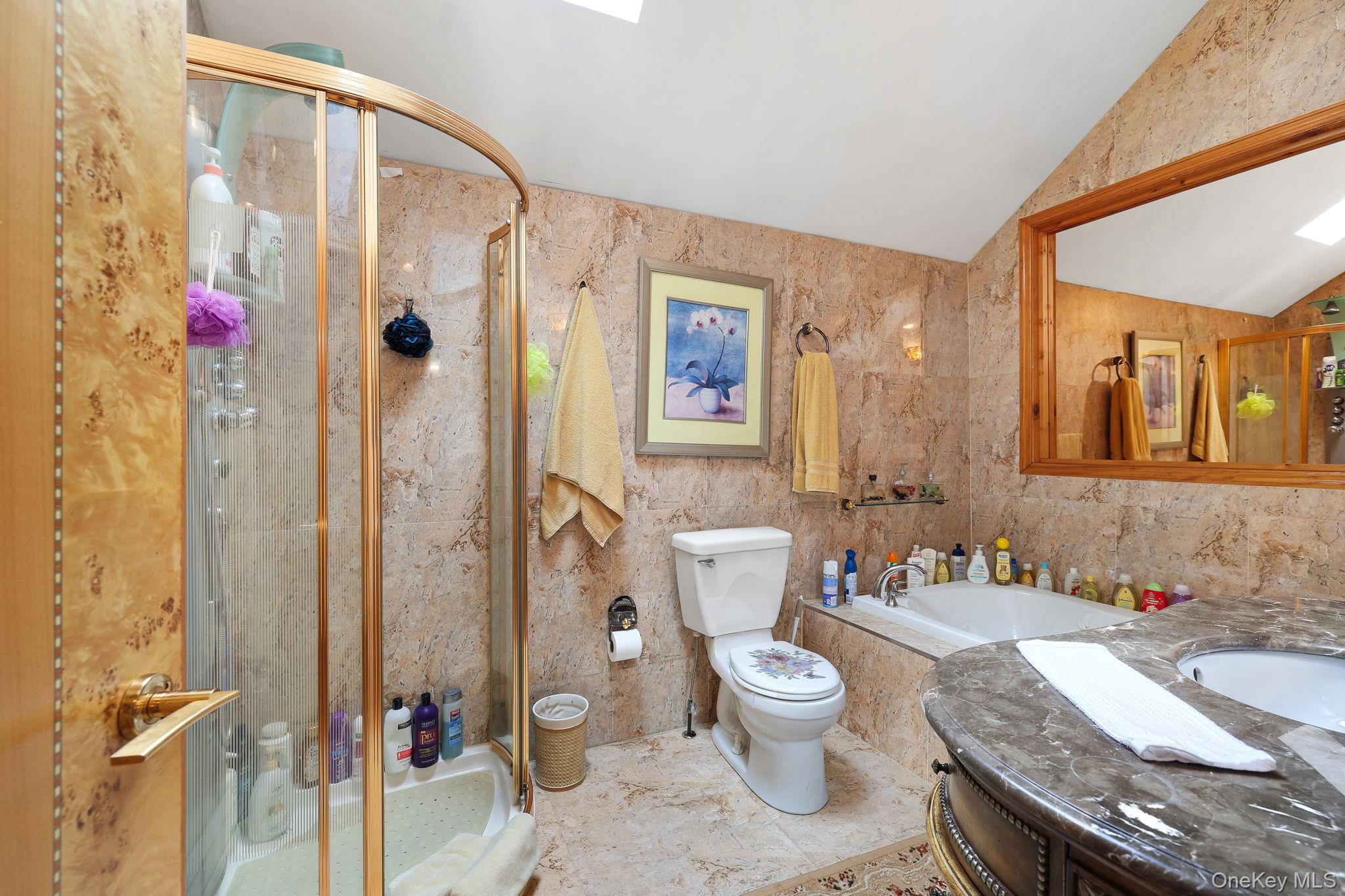 969 Hurd Road Jeffersonville, NY 12748 - Photo 18 of 33 a bathroom with a granite countertop sink a toilet a mirror and shower