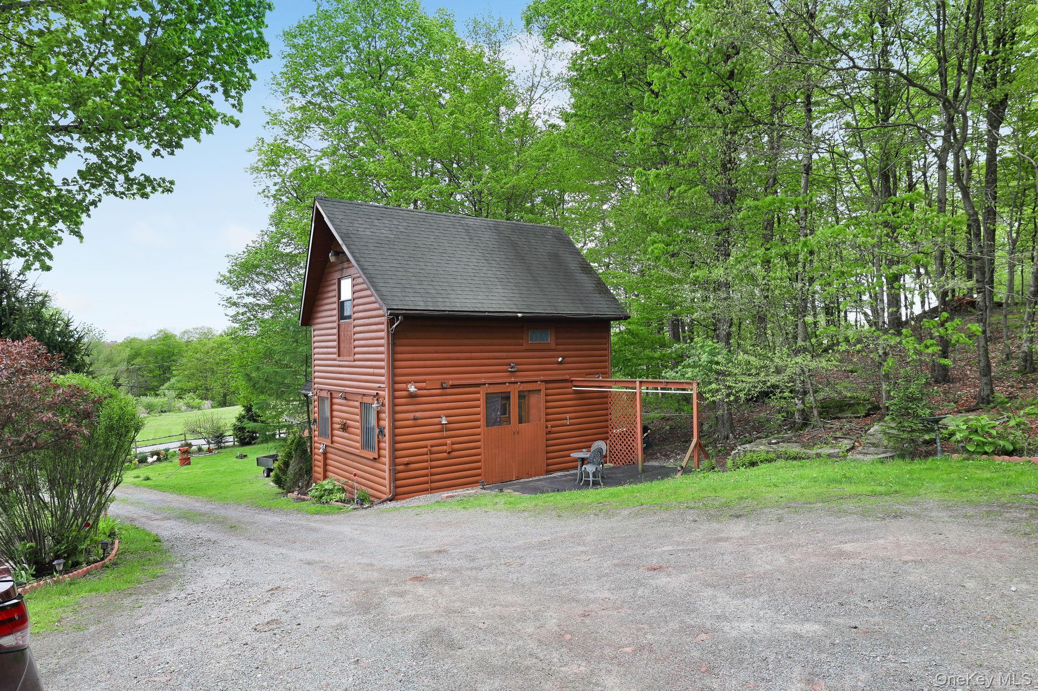 969 Hurd Road Jeffersonville, NY 12748 - Photo 24 of 33 a front view of a house with a garden and yard