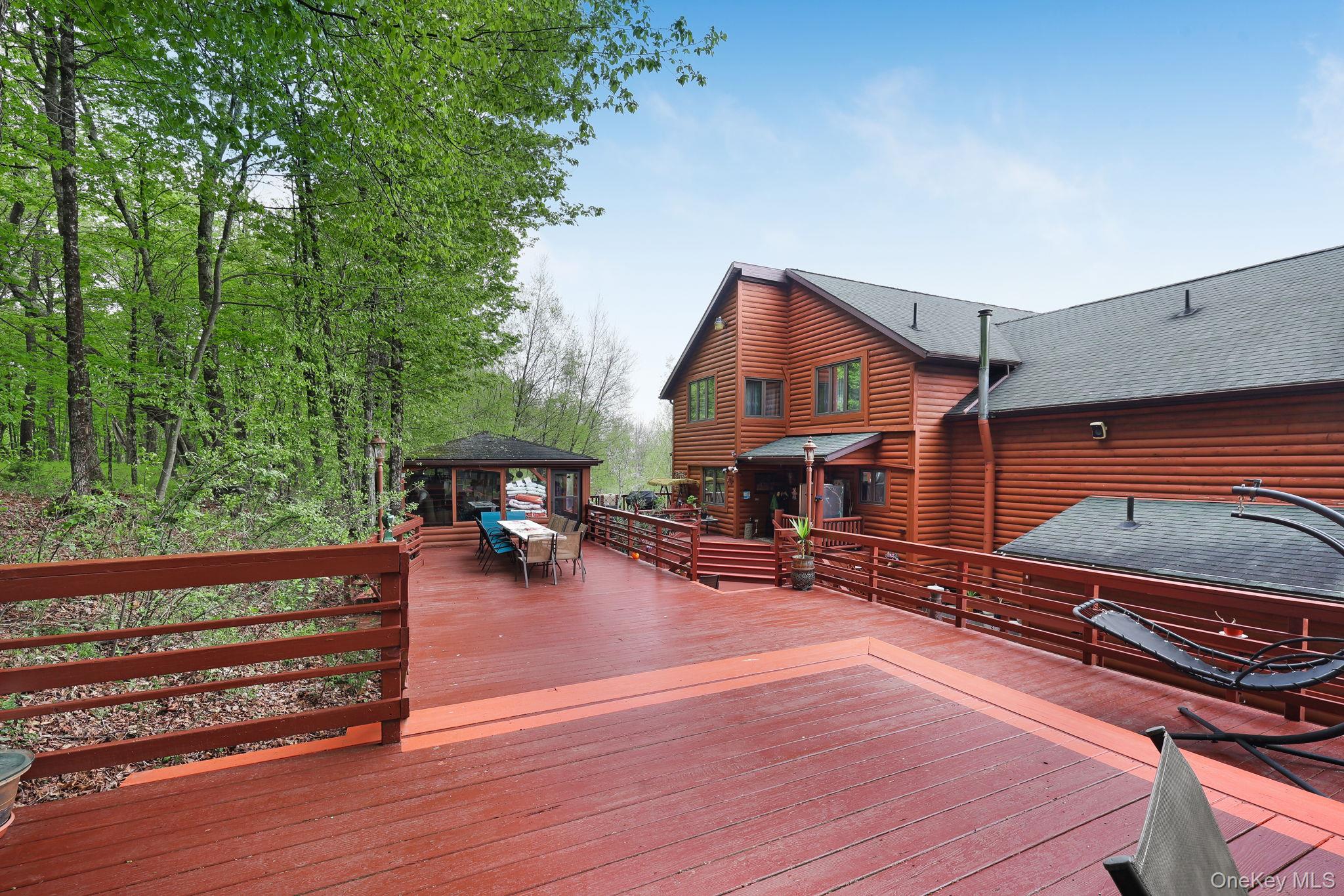 969 Hurd Road Jeffersonville, NY 12748 - Photo 31 of 33 a view of a house with wooden deck and sitting area