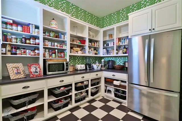 a kitchen with stainless steel appliances and cabinets
