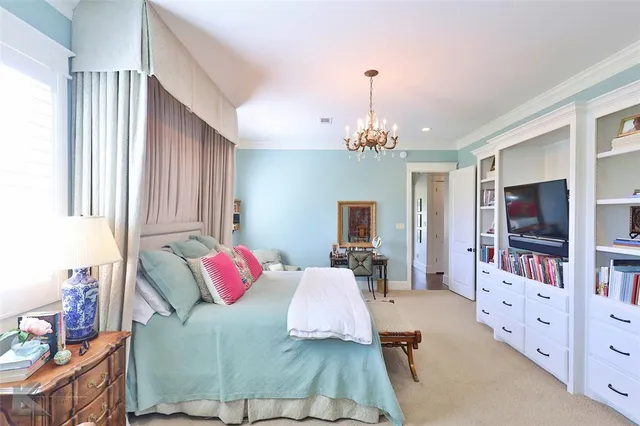 a bedroom with a bed and flat screen tv