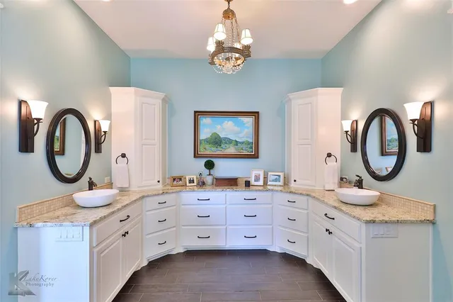 a bathroom with a double vanity sink and a mirror