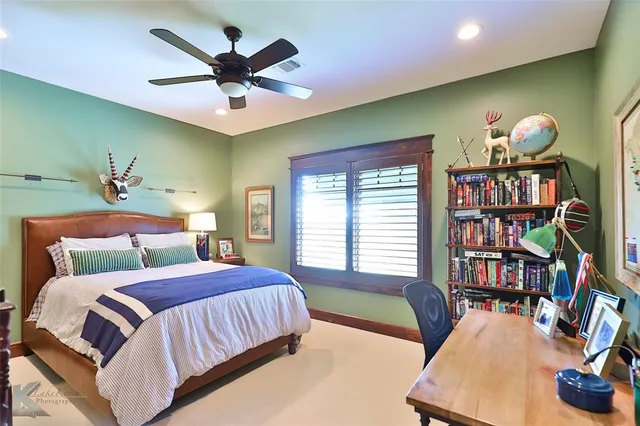 a bedroom with a large bed and a book shelf