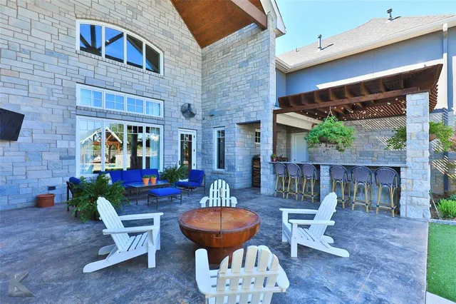 a view of a patio with couple of chairs and a fountain