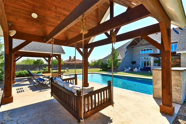 a view of a patio with a table chairs and a backyard