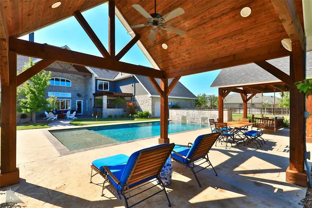 a view of a patio with chairs and table in the patio