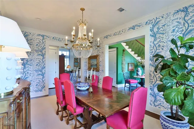 a view of a dining room with furniture a chandelier and wooden floor
