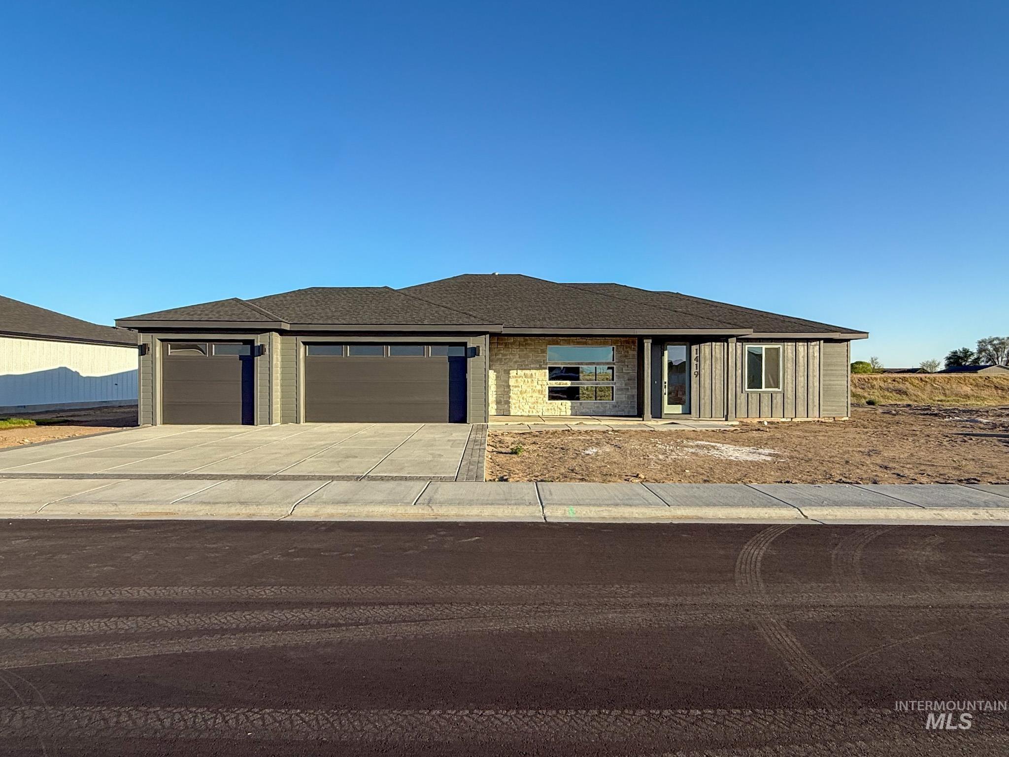 1419 Cardon Court Rupert, ID 83350 - Photo 1 of 15 Contemporary single-story residence featuring a dark shingle roof and a two-car garage with modern doors