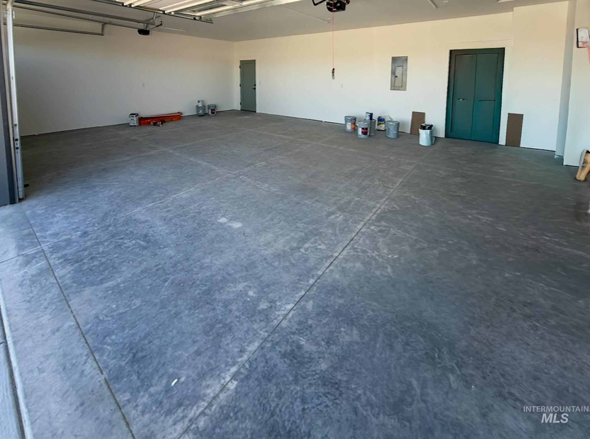 1419 Cardon Court Rupert, ID 83350 - Photo 13 of 15 Spacious garage featuring a concrete floor, painted white walls, and a visible electrical panel