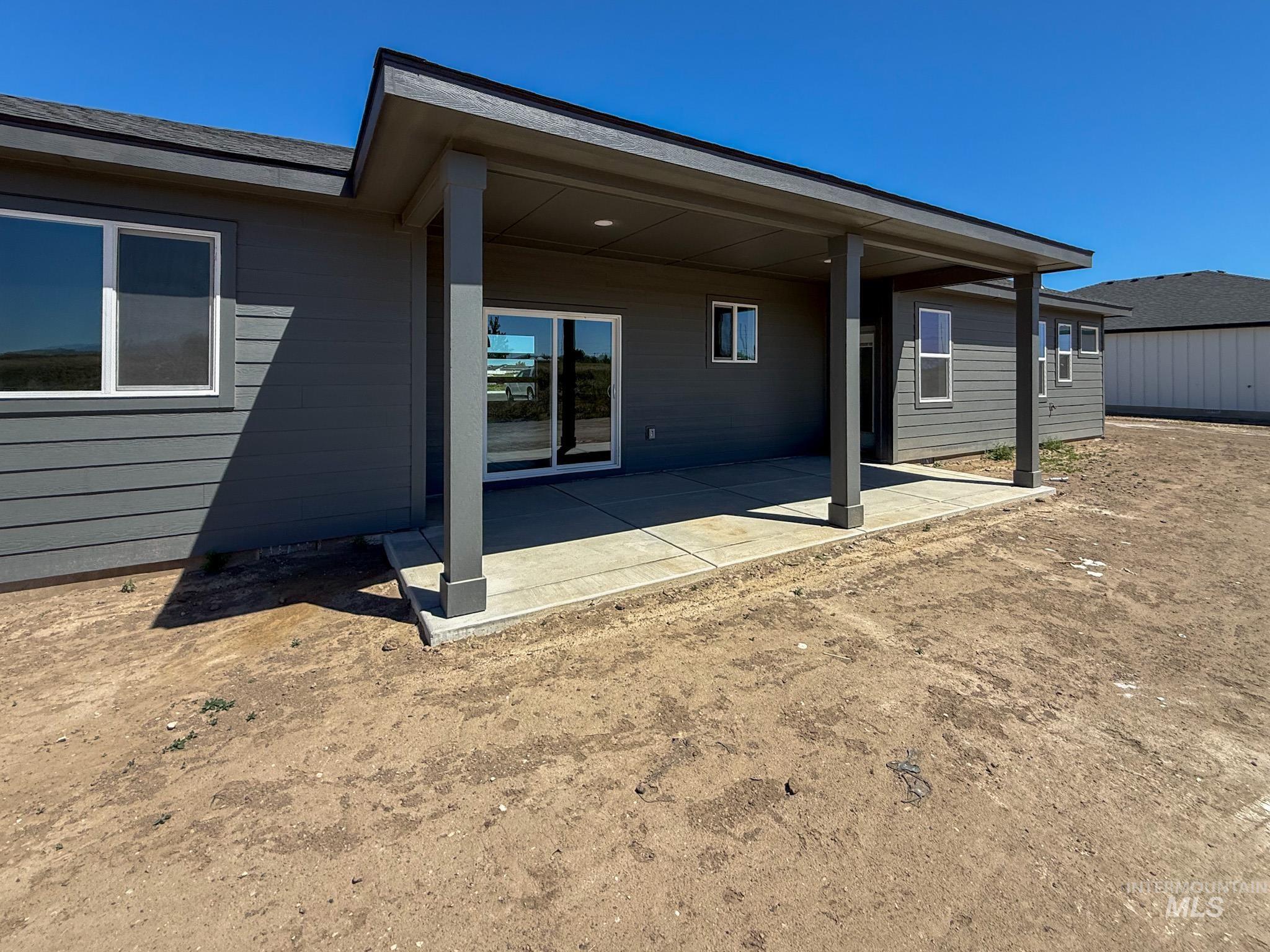 1419 Cardon Court Rupert, ID 83350 - Photo 14 of 15 Covered concrete patio with a dark gray exterior, horizontal siding, and multiple windows