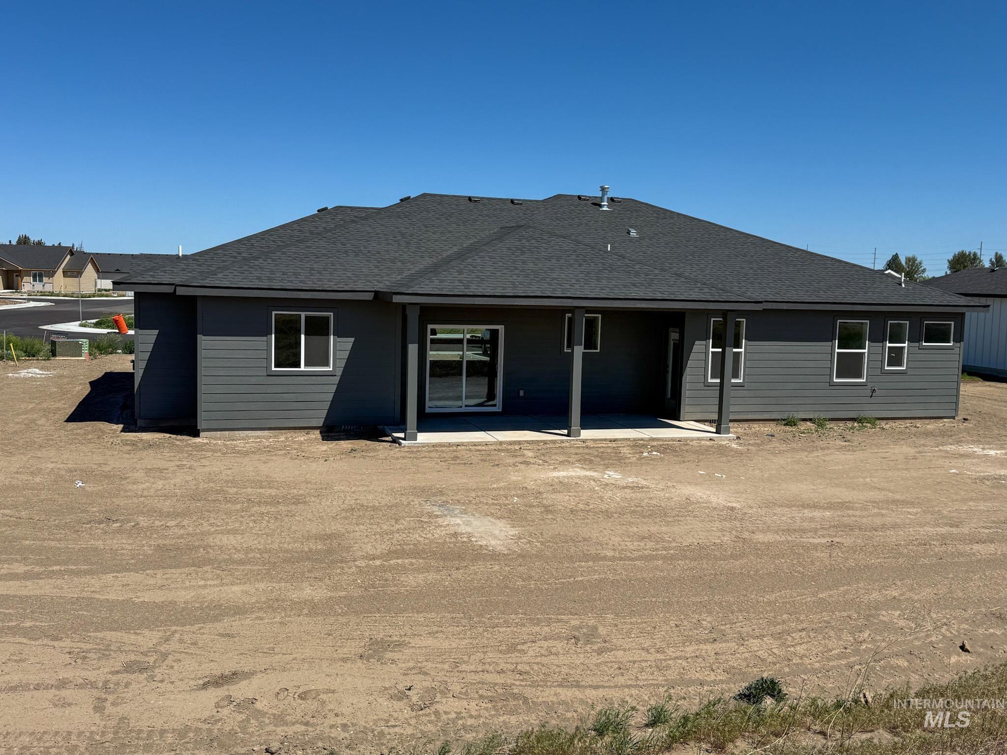 1419 Cardon Court Rupert, ID 83350 - Photo 15 of 15 Rear exterior featuring dark gray siding and a covered patio