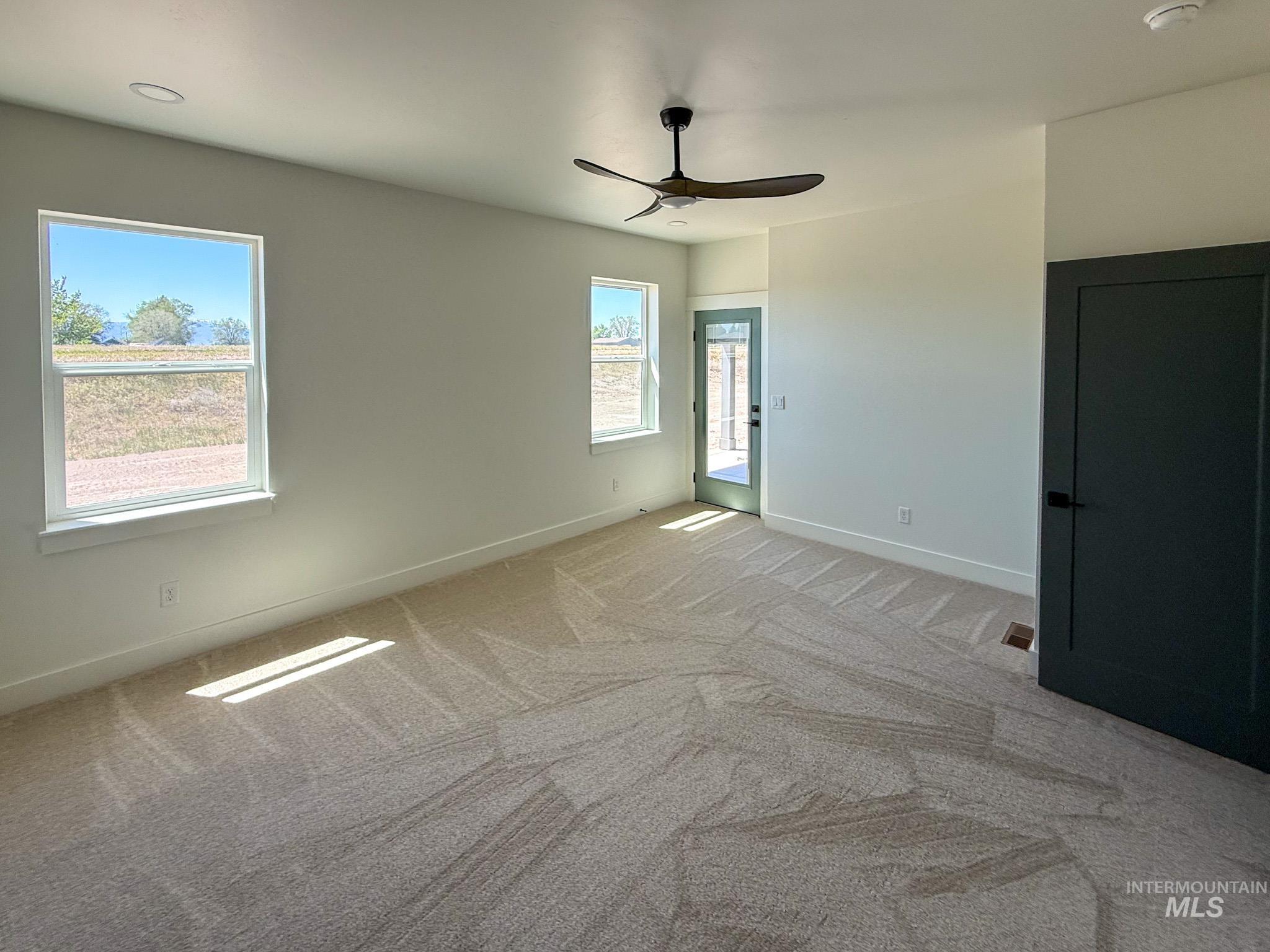 1419 Cardon Court Rupert, ID 83350 - Photo 7 of 15 Spacious room featuring neutral carpeting, recessed lighting, and a contemporary ceiling fan