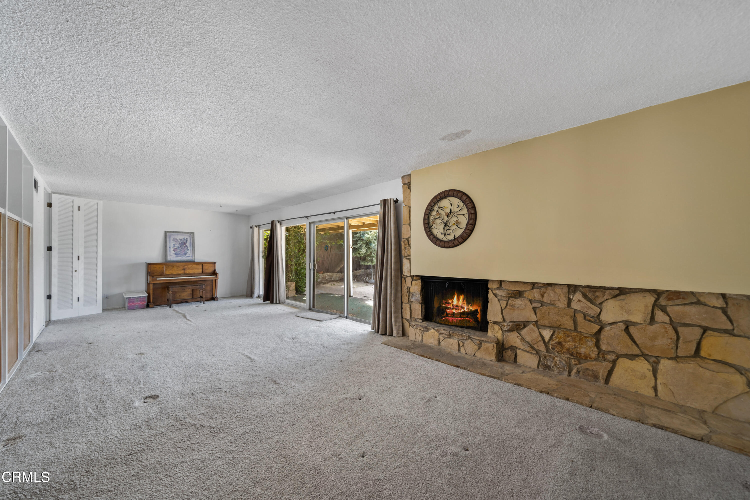 7024 Charrick Place Tujunga, CA 91042 - Photo 16 of 45 a view of an empty room with a fireplace and a window