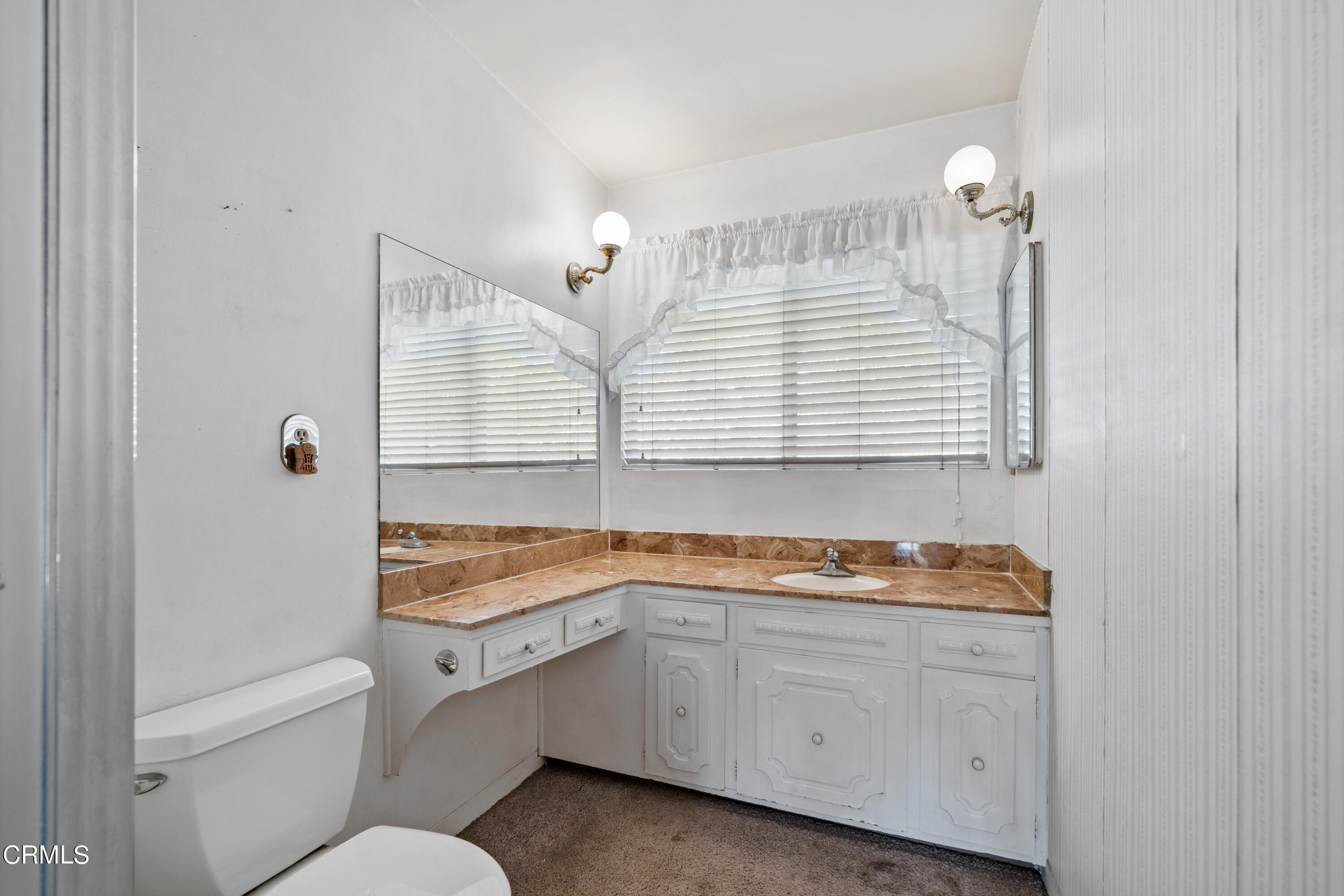 7024 Charrick Place Tujunga, CA 91042 - Photo 19 of 45 a bathroom with a granite countertop sink and a window