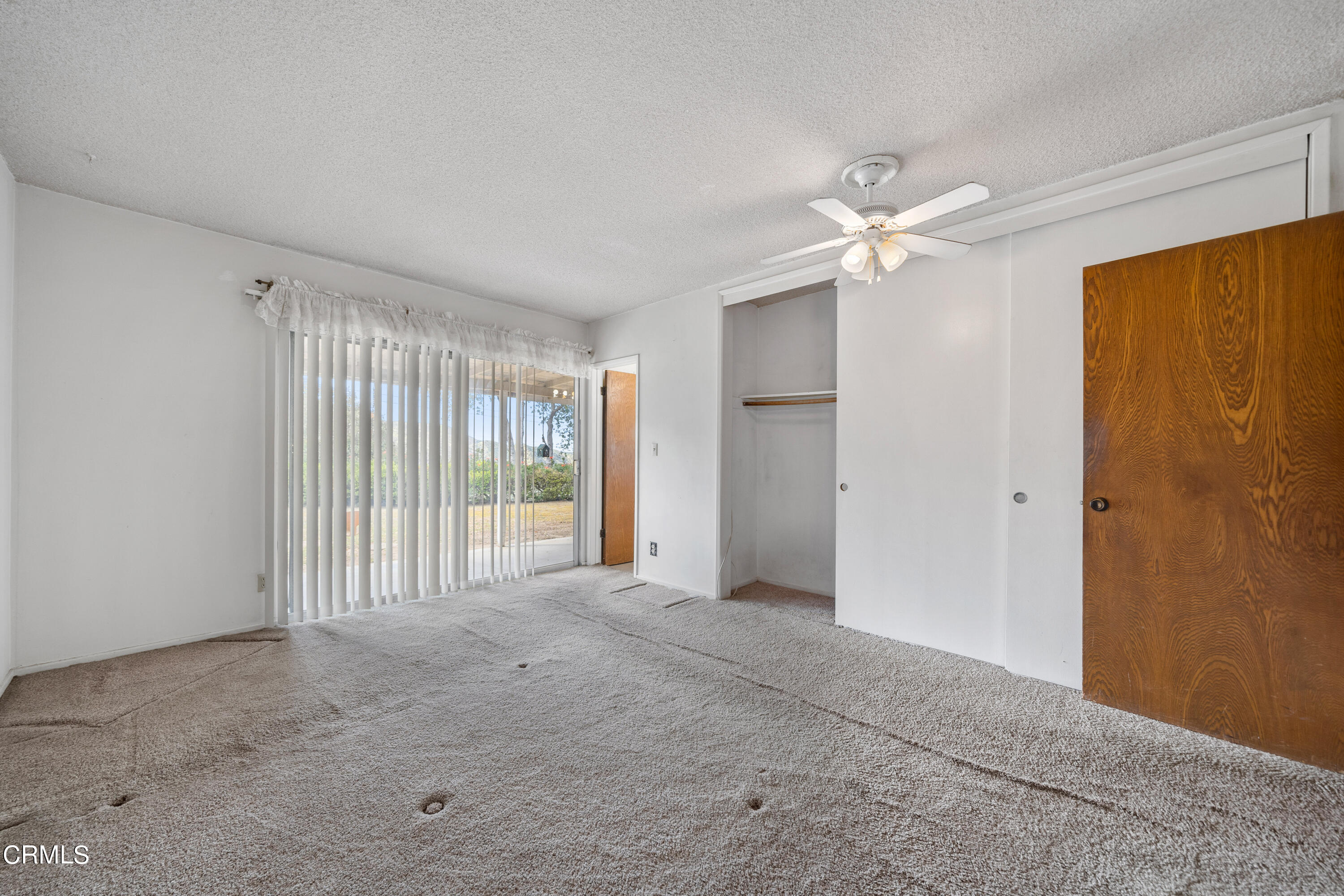 7024 Charrick Place Tujunga, CA 91042 - Photo 25 of 45 a view of a livingroom with a ceiling fan & windows
