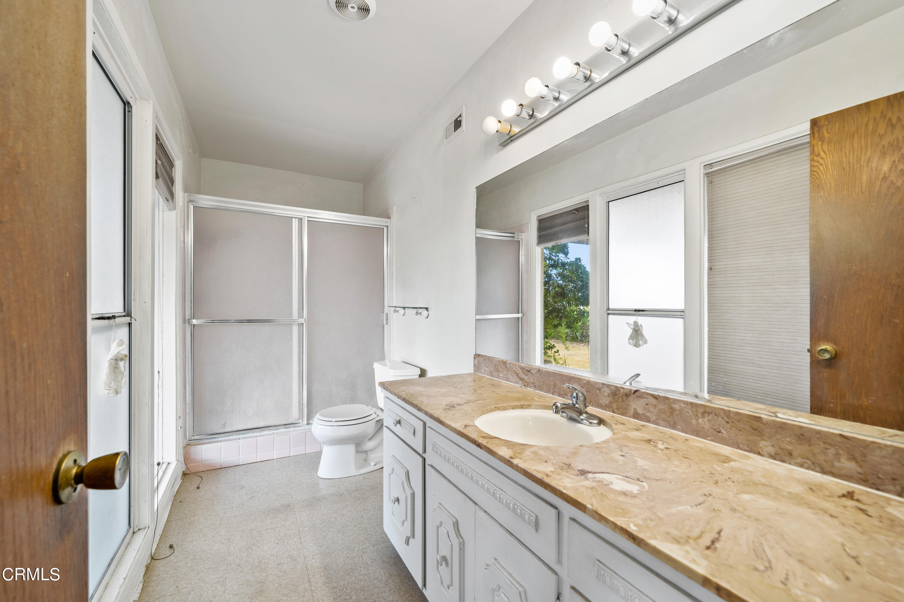 7024 Charrick Place Tujunga, CA 91042 - Photo 27 of 45 a spacious bathroom with a granite countertop sink a large mirror and a shower