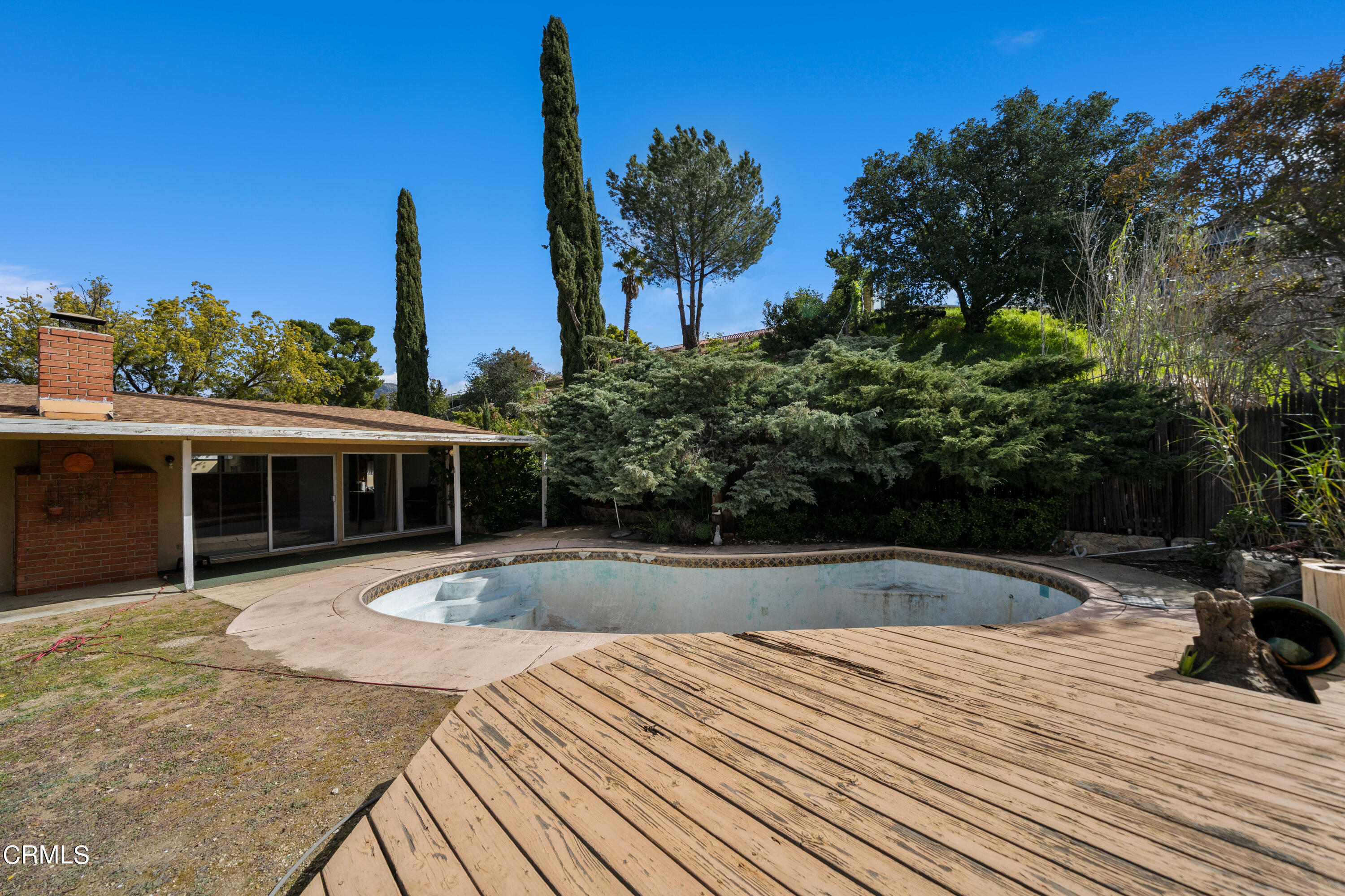 7024 Charrick Place Tujunga, CA 91042 - Photo 32 of 45 a view of outdoor space with swimming pool and trees in the background