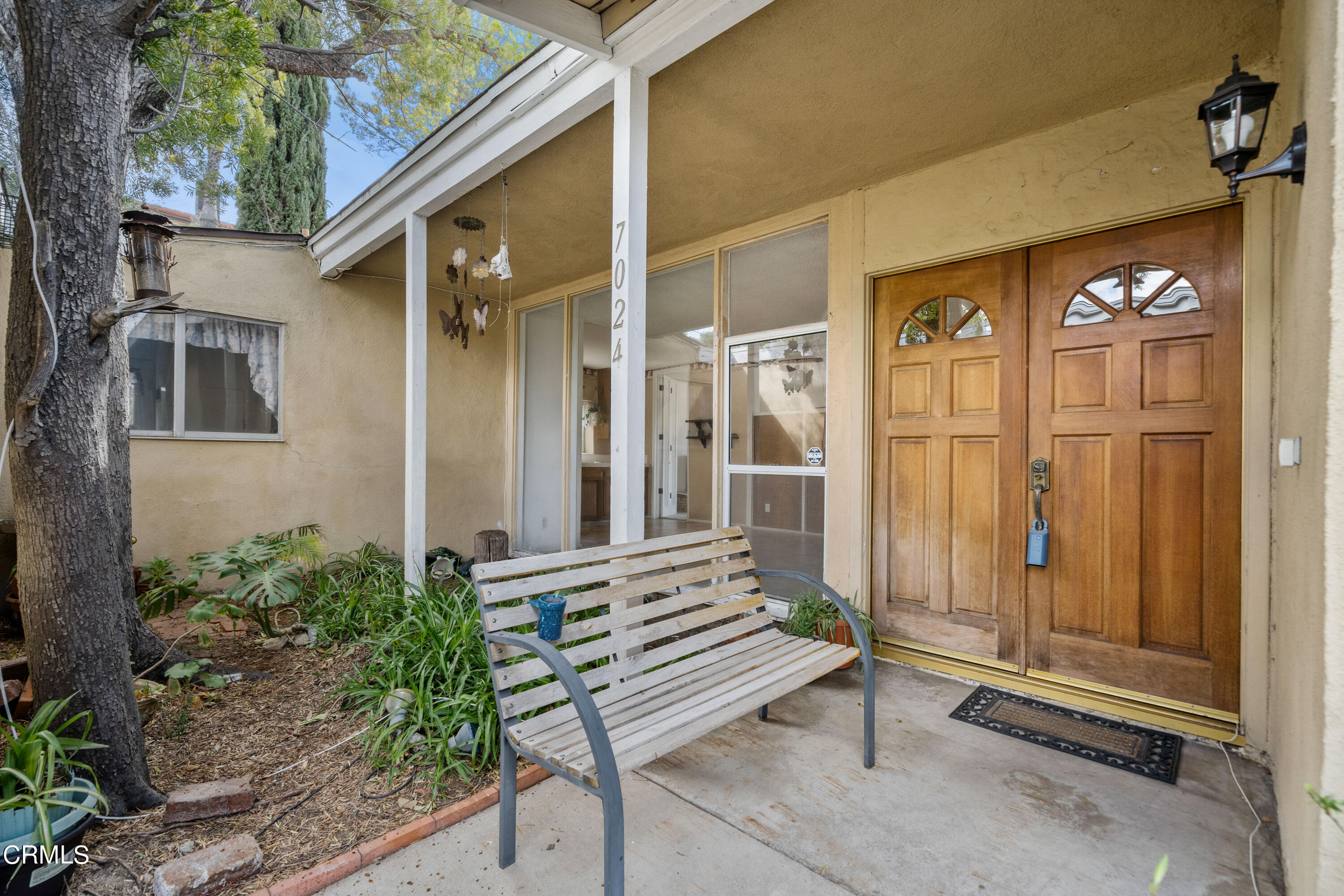 7024 Charrick Place Tujunga, CA 91042 - Photo 4 of 45 a view of a house with a door and wooden bench