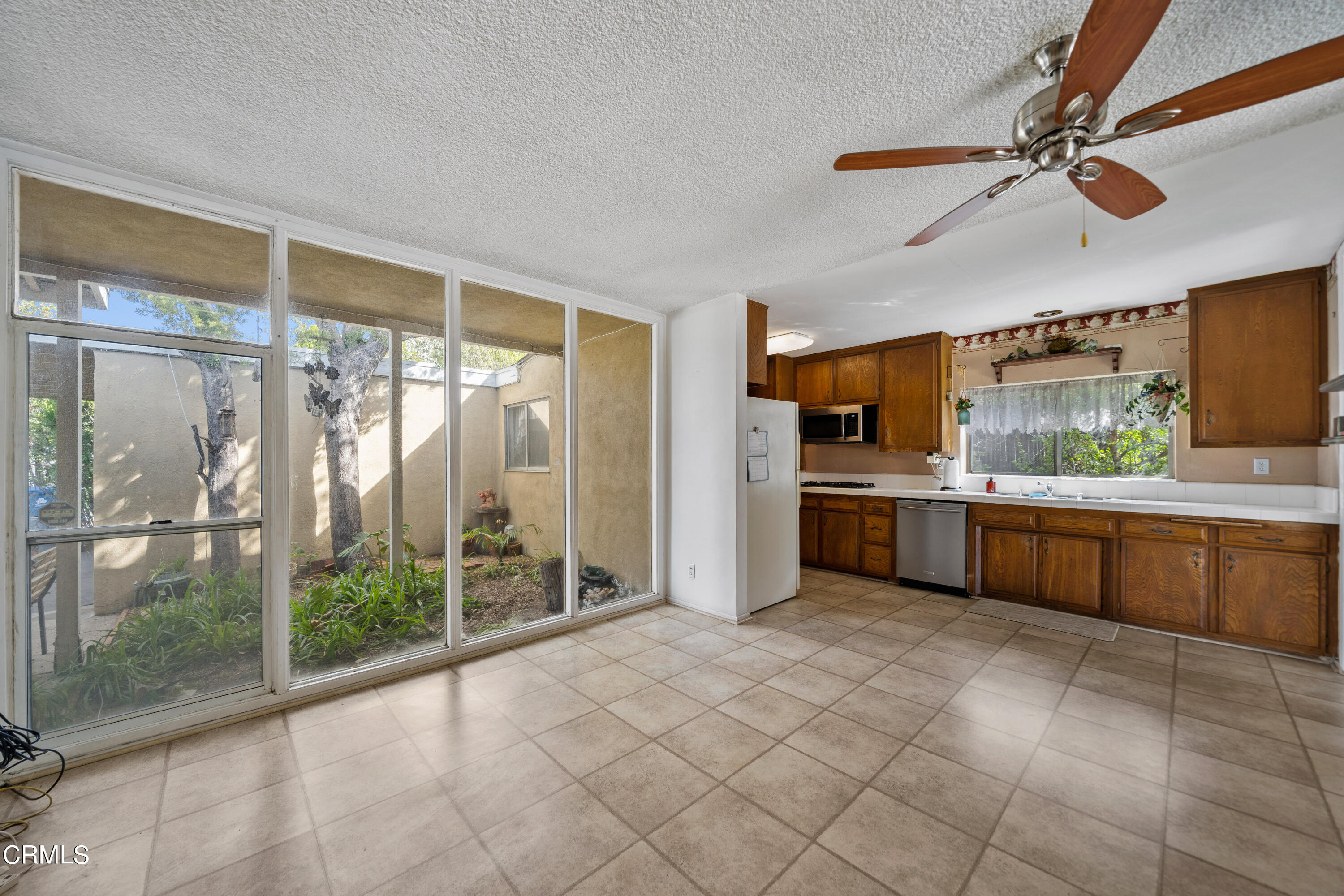 7024 Charrick Place Tujunga, CA 91042 - Photo 7 of 45 a large kitchen with a large window cabinets and stainless steel appliances