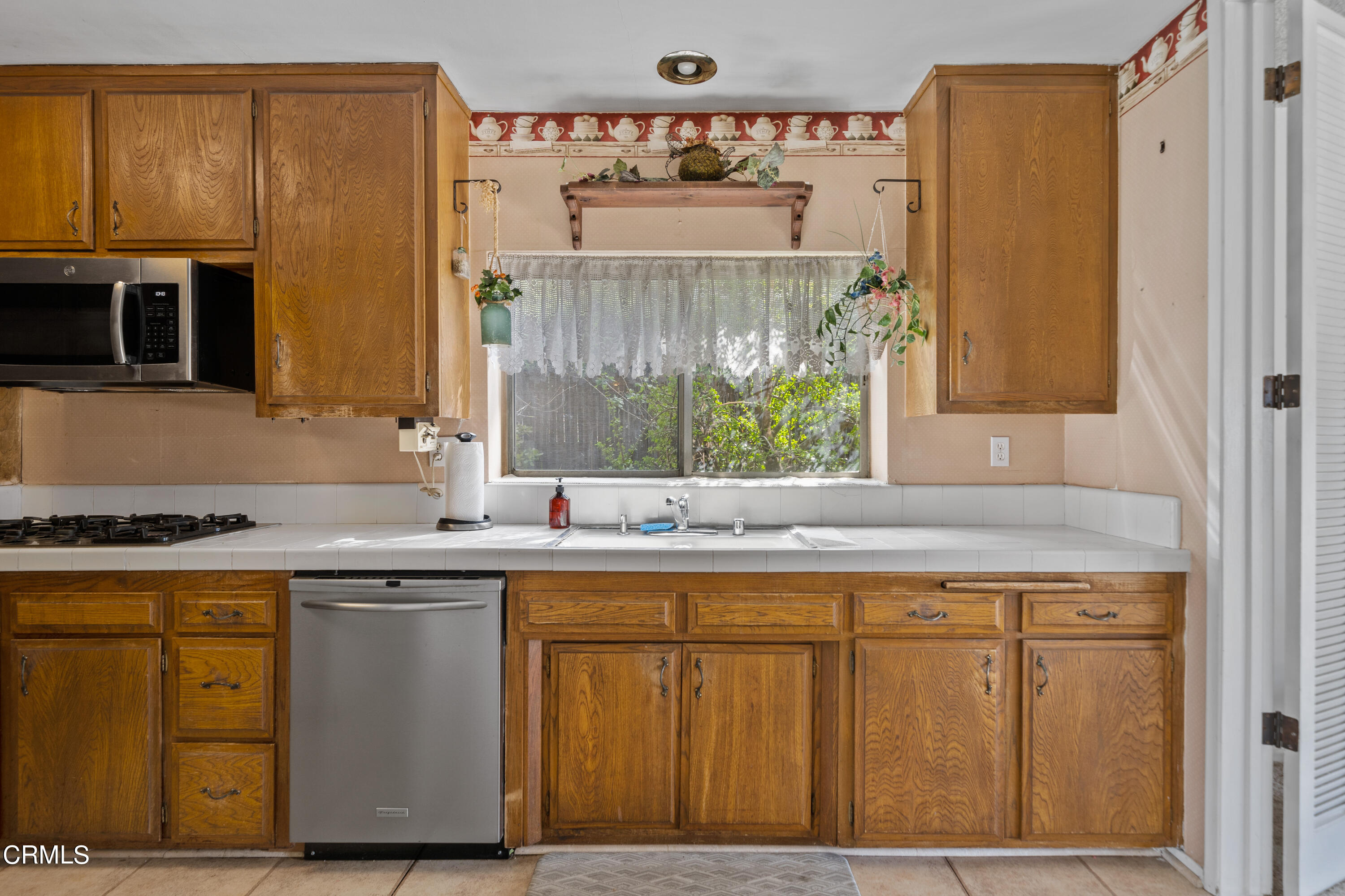 7024 Charrick Place Tujunga, CA 91042 - Photo 9 of 45 a kitchen with a sink and cabinets