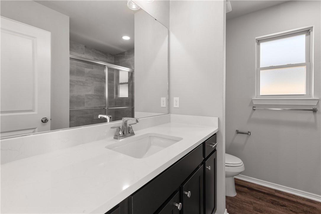 2869 Messenger Way Bryan, TX 77803 - Photo 15 of 23 a bathroom with a sink a toilet and a mirror