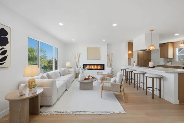 a living room with furniture a large window and a table