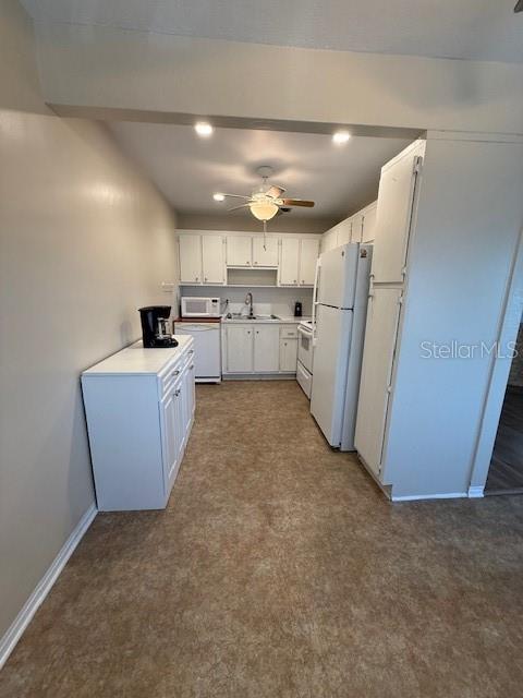 11251 80th Avenue, Unit 309 Seminole, FL 33772 - Photo 5 of 15 a kitchen with refrigerator and white cabinets